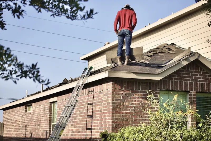 Professional roofer working on a residential roof in Hydeville